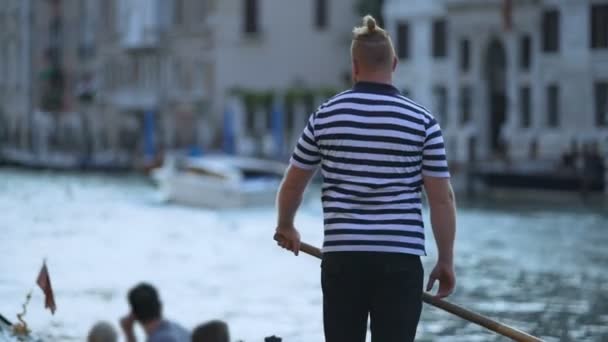 Elegante barcaiolo veneziano che spinge gondola con turisti stranieri, guadagnando soldi — Video Stock
