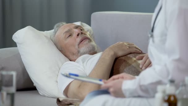 Hombre jubilado acostado en la cama y charlando con el médico, la salud y la medicina — Vídeos de Stock