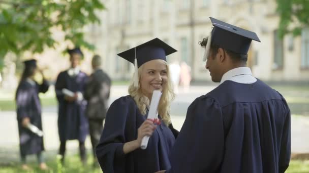 Graduados universitarios conversando, abrazándose, amistad universitaria — Vídeo de stock