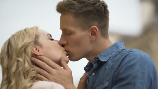 Mann schaut Freundin an und küsst sie auf die Lippen, erste Liebe, starke Gefühle — Stockvideo