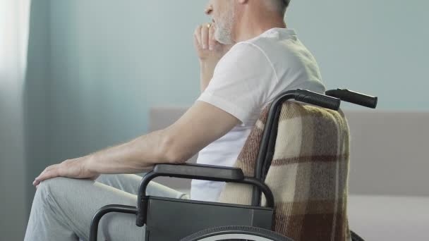 Senior man in wheelchair, nurse taking care of disabled patient, medical center — Stock Video