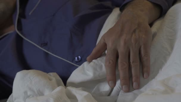 Hand of elderly man lying on blanket at night, sound untroubled sleep, rest — Stock Video