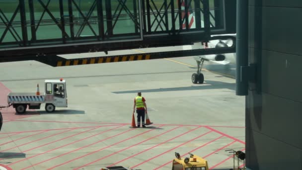 Werknemer van luchthaven houden verkeer kegels, technisch onderhoud van vliegtuigen — Stockvideo