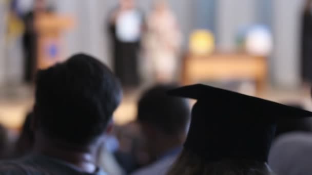 Rector's farewell speech at graduation ceremony, happy students looking at stage — Stock Video