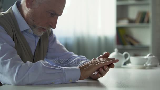 Depressieve oudere man zit op de keukentafel, weduwnaar eenzaamheid lijden — Stockvideo