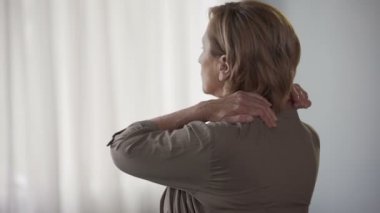 Geriye doğru ayakta, sürtünme boyun ve omuz, sert kas yaşlı kadın