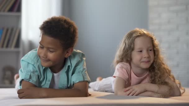 Cute little children clumsily flirting with each other, first childhood love — Stock Video