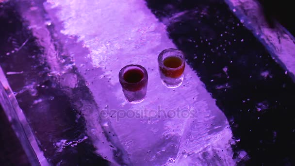 Hands taking cold glasses with beverage and drinking to bottom, original ice bar — Stock Video