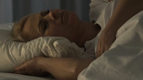 Unhealthy senior female sleeping in bed and suffering from terrible nightmares — Stock Video