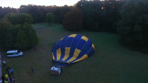 Air ballonghöljet komma uppblåst på marken, solen stiger på horisonten, antenn — Stockvideo