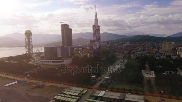 Batumi downtown in light haze against mountain skyline, early evening in city — Stock Video