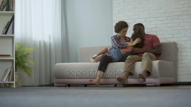 Cheio de amor e cuidados pais se divertindo com sua pequena filha de cabelos encaracolados — Vídeo de Stock