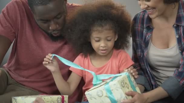 Happy daughter opens Christmas presents together with beloved parents, holidays — Stock Video