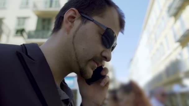 Inattantive man talking over phone and preparing to cross busy street in city — Stock Video