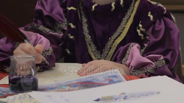 Young male writing billet-doux letter with quill, costume party of Medieval Ages — Stock Video