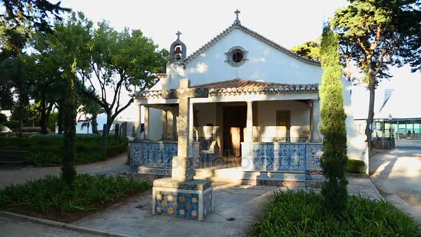 Каменный крест, стоящий перед маленькой старой часовней в Португалии, туристическое направление — стоковое видео