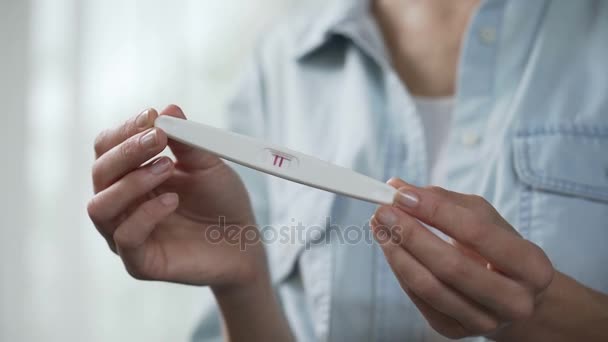 Female enjoying positive pregnancy test result, demonstrating it before camera — Stock Video