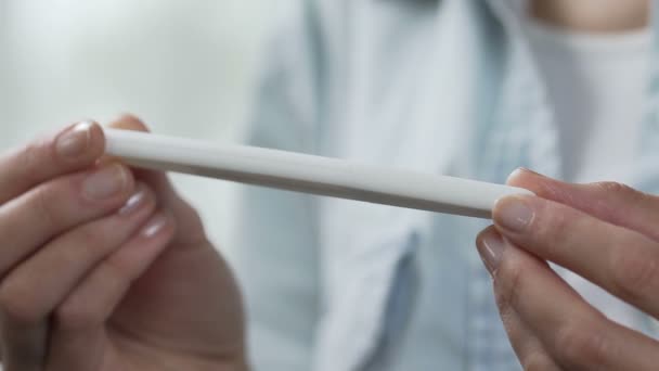 Female hands holding pregnancy test, turning to show two lines, family planning — Stock Video