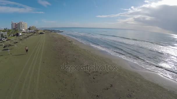 Homem relaxado desfrutando fim de semana na praia vazia, baixa temporada em Larnaca, Chipre — Vídeo de Stock