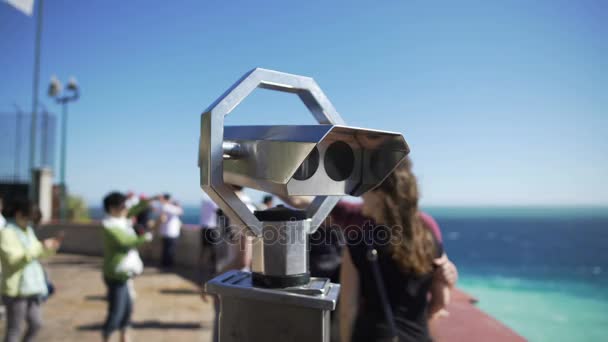 Binoculars at observation deck on sunny day, people moving around at background — Stock Video