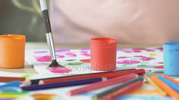 Child mixing drawing colors with brush, close-up of gouache paint  cans, art — Stock Video