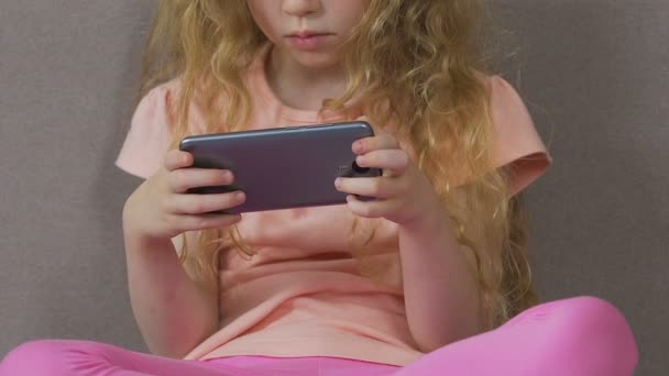 Little girl addicted to smartphone, can't stop using mobile device, dependence — Stock Video