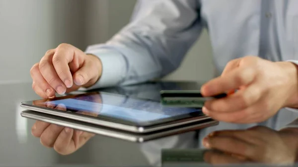 Männliche Hände machen bargeldlose Online-Zahlung auf dem Tablet, geben Bankkartendaten ein — Stockfoto