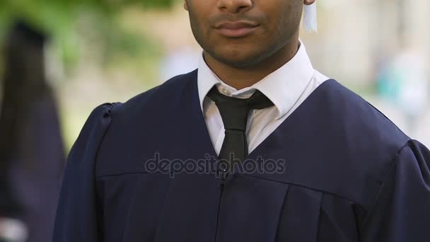 Orgulloso estudiante masculino graduándose de la universidad con diploma, oportunidades futuras — Vídeos de Stock