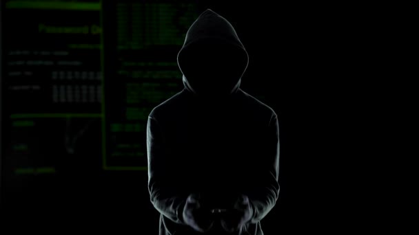 Silhouette of handcuffed angry hacker on animated computer code background — Stock Video