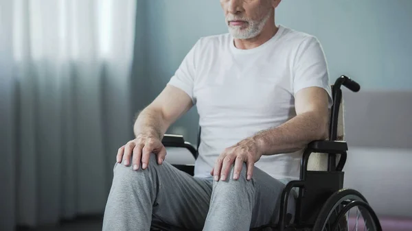 Hombre indefenso con discapacidades sentado en silla de ruedas y tratando de moverse, salud —  Fotos de Stock