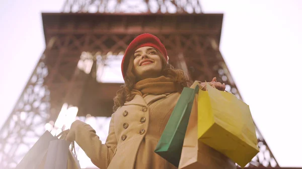 Beautiful lady having successful shopping in Paris, shopaholic with many bags Royalty Free Stock Photos