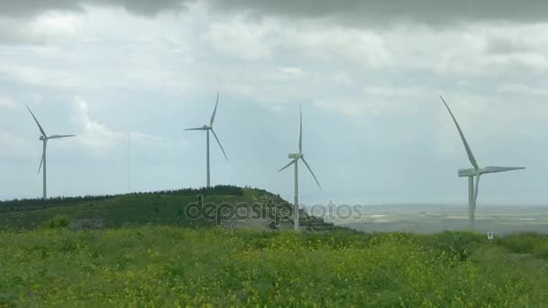 Wind turbine propellers spinning in wind, windmills in beautiful green field — Stock Video