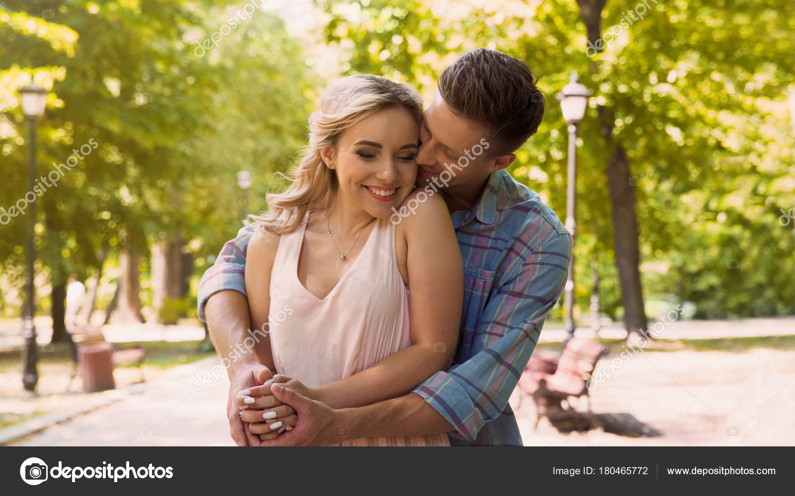 Handsome boyfriend hugging his beautiful girlfriend, romantic date