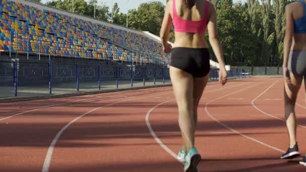 Wieloetnicznego studentek, przechodząc do szatni po treningu na stadionie — Wideo stockowe