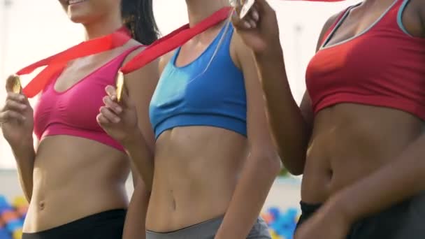 Slanke vrouwelijke winnaars tonen hun medailles, poseren voor foto's bij de toekenning ceremonie — Stockvideo