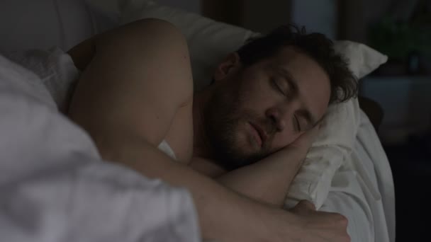 Adult bearded man sleeping in bed, exhausting day, sound sleep and night rest — Stock Video