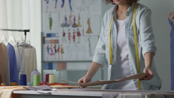 Fashion designer working patterns in her studio, clothing industry, business — Stock Video