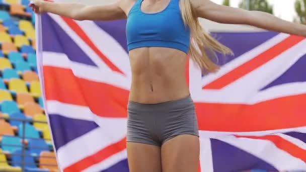 Όμορφη αθλήτρια κερδίζοντας ανταγωνισμού, αθλητής, κρατώντας την σημαία της Μεγάλης Βρετανίας — Αρχείο Βίντεο