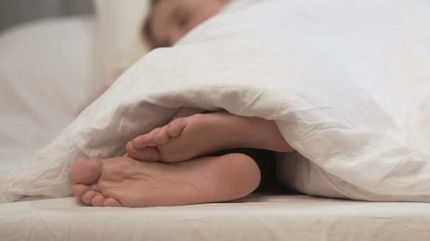 Feminino coçar o pé sob cobertor branco, necessidade de tratamento médico de alergia — Vídeo de Stock