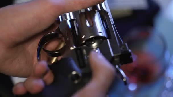 Man in desperate put bullet into revolver, playing Russian roulette, close up — Stock Video