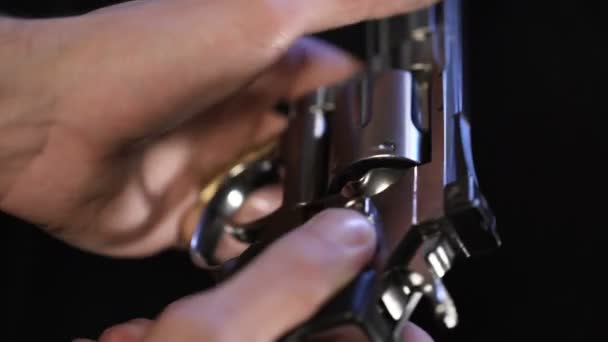 Man put bullet into revolver, spinning barrel, going to play Russian roulette — Stock Video