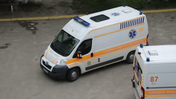 Driver of new ambulance car parking near to hospital, emergency medical service — Stock Video