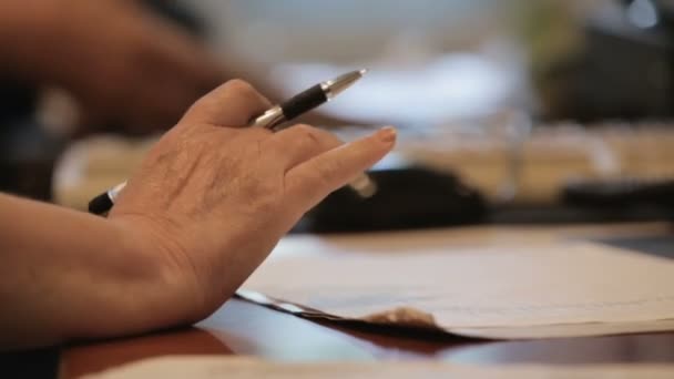 Female nurse working with papers hospital office, checking doctor work schedule — Stock Video