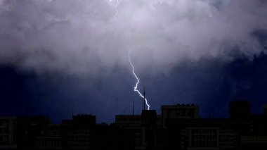 Ağır fırtına bulutların üzerinde şehir rooftops, Şimşekli, iklim
