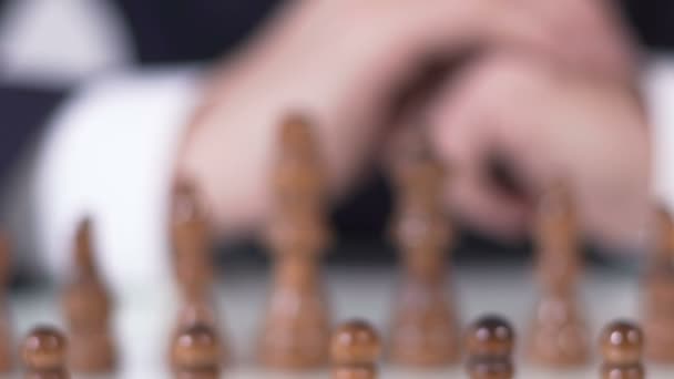 Close up of male hand moving pawn in chess game, business and political strategy — Stock Video