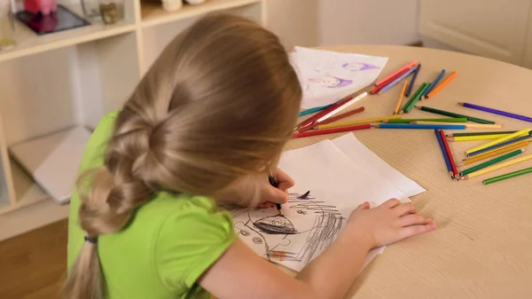 Little girl drawing stranger from her nightmare with black pencil, child fears — Stock Photo, Image