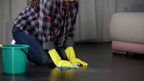 Lady trying to get rid of stains on floor with special remover, polishing liquid — Stock Photo, Image