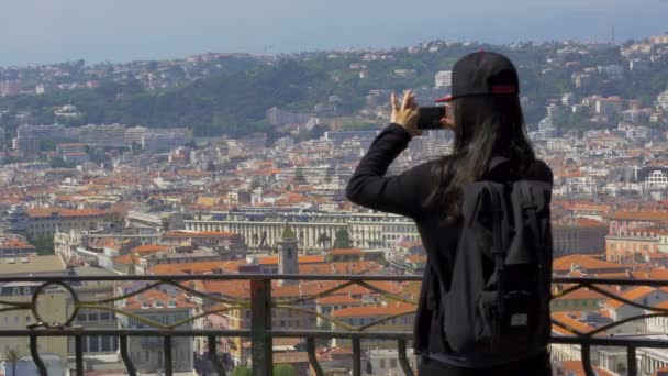 Nice, Frankrijk - Circa juni 2016: Mensen in de stad. Vrouwelijke toeristische fotograferen mooie stadsgezicht op mobiel, reizen — Stockvideo