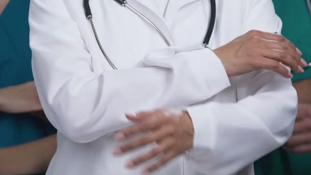 Close up van ervaren medisch personeel met gekruiste handen poseren voor camera — Stockvideo