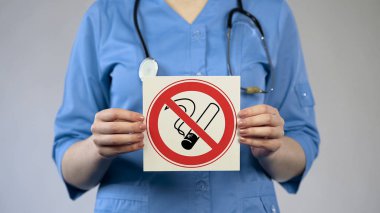 Physician showing no smoking sign, specialist warning about harm of tobacco use clipart